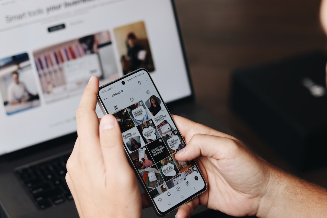hero-img A person is using their smartphone to browse the SumUp Instagram profile, focusing on posts related to marketing strategies and business tips. In the background, a laptop displays a webpage about tools for business growth, suggesting a workspace or content creation environment. This image highlights the use of social media for brand promotion, digital marketing, and business engagement, making it relevant for content creators, marketers, and entrepreneurs.